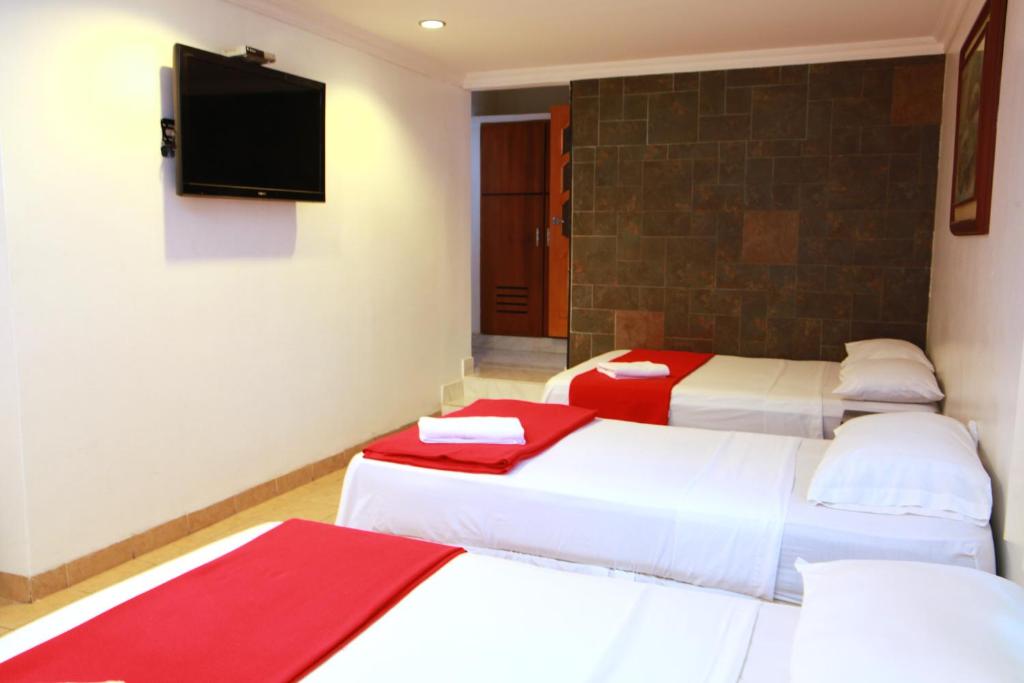 Postel nebo postele na pokoji v ubytování Hotel Apart Guayaquil Aeropuerto