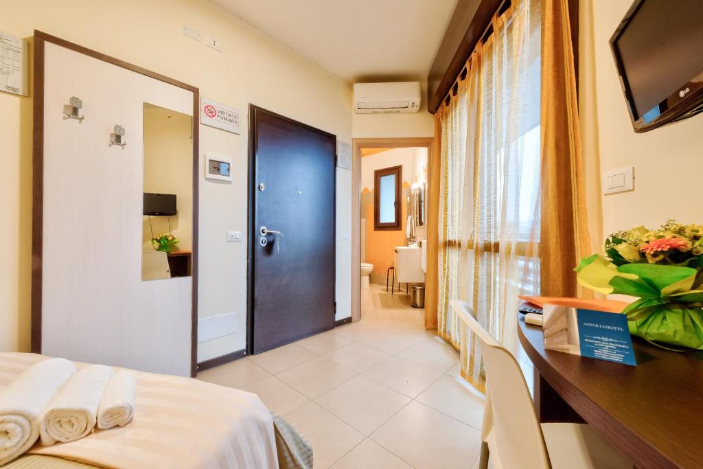 Łóżko lub łóżka w pokoju w obiekcie AppartaHotel