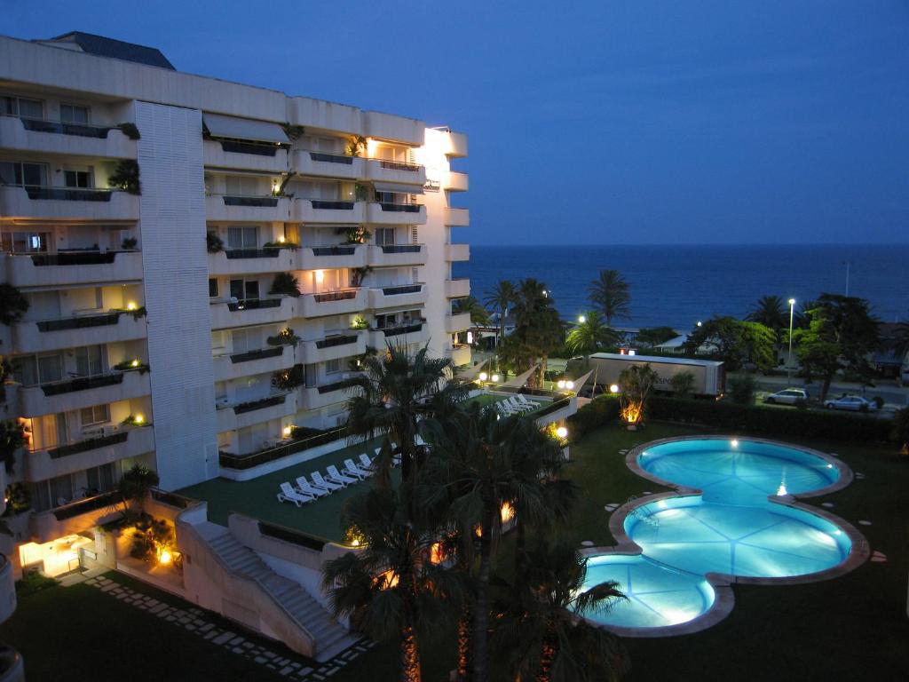 a view of a hotel at night with swimming pools at Mediterraneo Sitges in Sitges