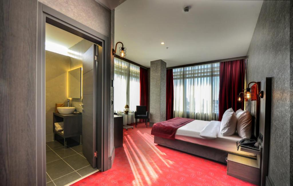 a hotel room with a bed and a bathroom at A11 Hotel Atasehir in Istanbul
