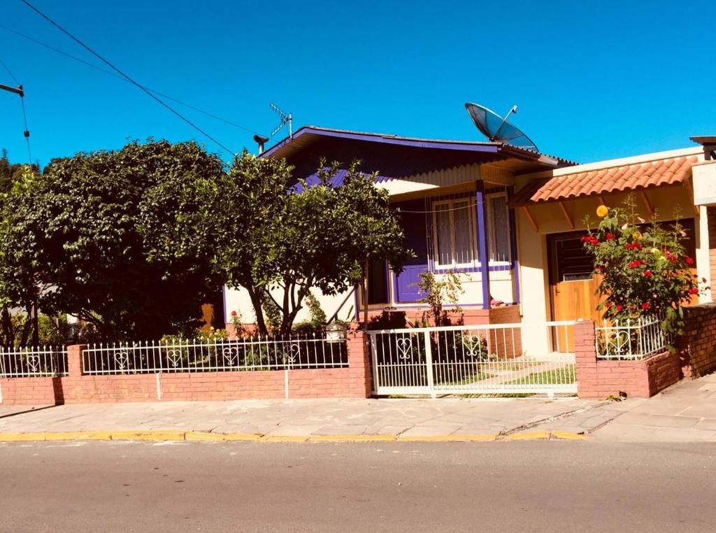 a house with a fence in front of it at Casa Santos Dumont in Gramado