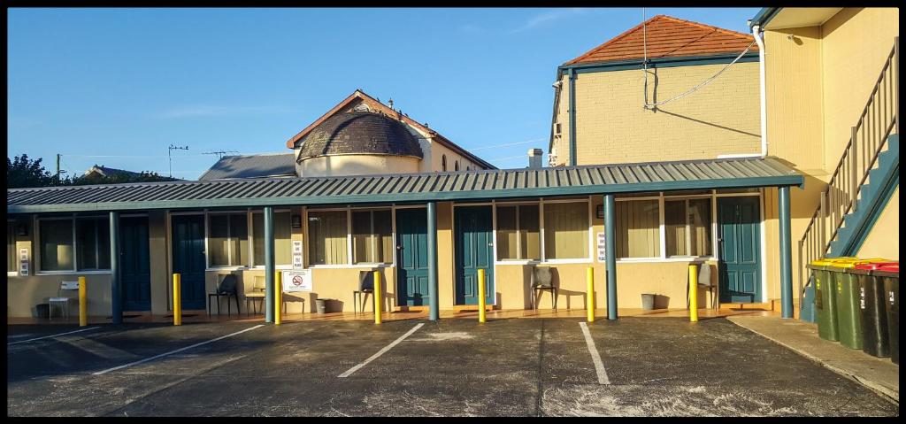 an empty parking lot in front of a building at Windsor Motel in Windsor