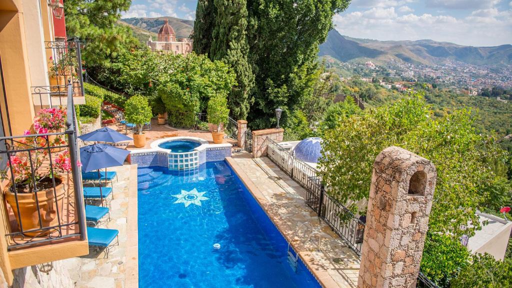 a swimming pool in the middle of a house at Casa Estrella de la Valenciana Hotel Boutique in Guanajuato