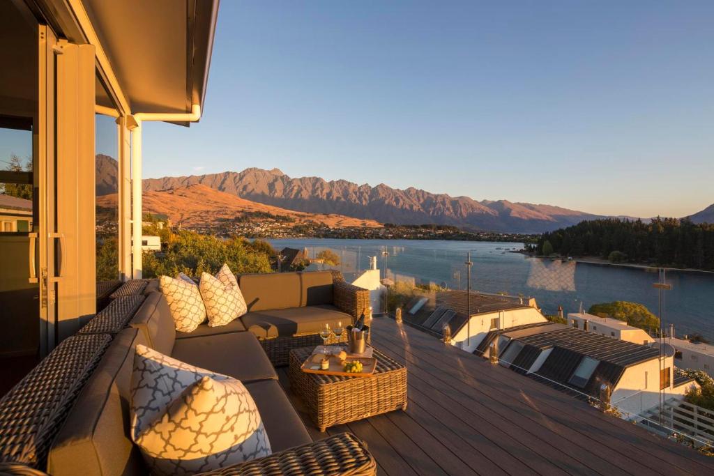 a balcony with a view of a body of water at Lakefront Luxury by Amazing Accom in Queenstown