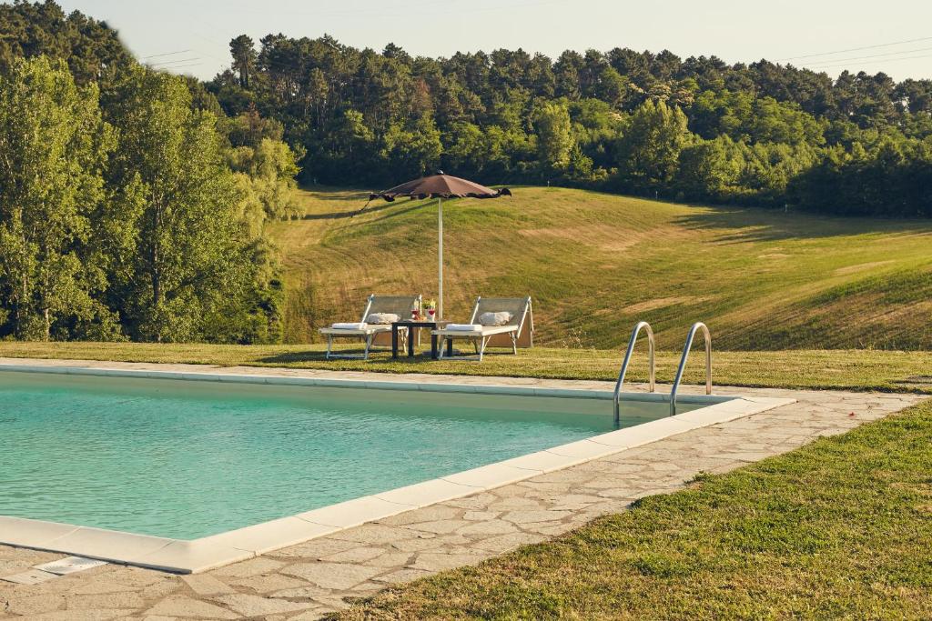 a pool with a pool table and chairs in it at Il Casale di Santamettole in Barberino di Mugello