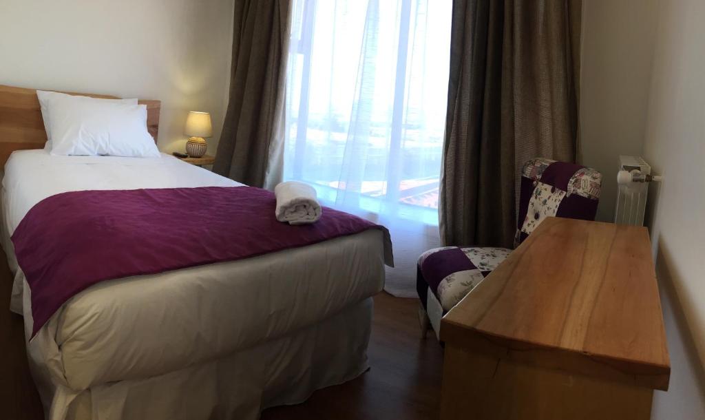 Postel nebo postele na pokoji v ubytování Hostal Doble E Patagonia