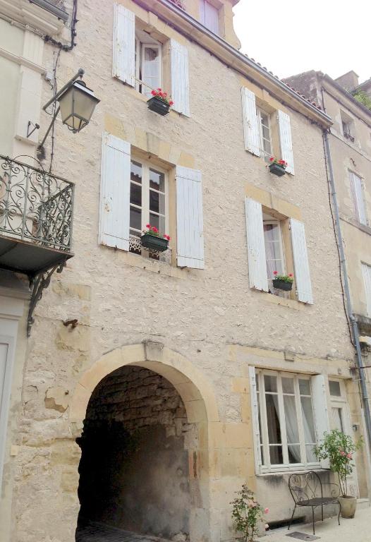 a building with an archway in a building with windows at My Little French House in Monflanquin
