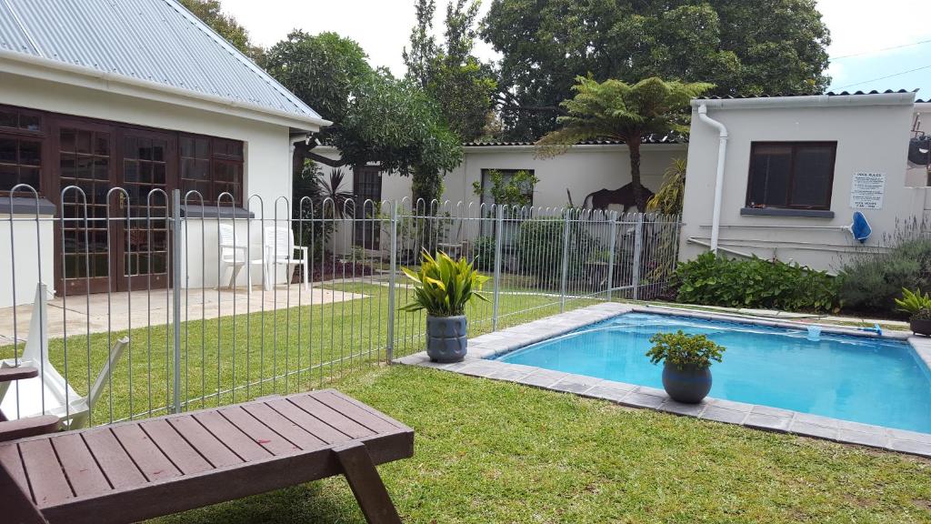 a fence around a swimming pool in a yard at 39 On Nile Guest House in Port Elizabeth