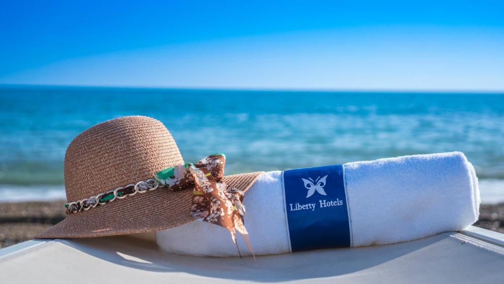 a straw hat sitting on a table at the beach at Liberty Hotels Lara in Lara