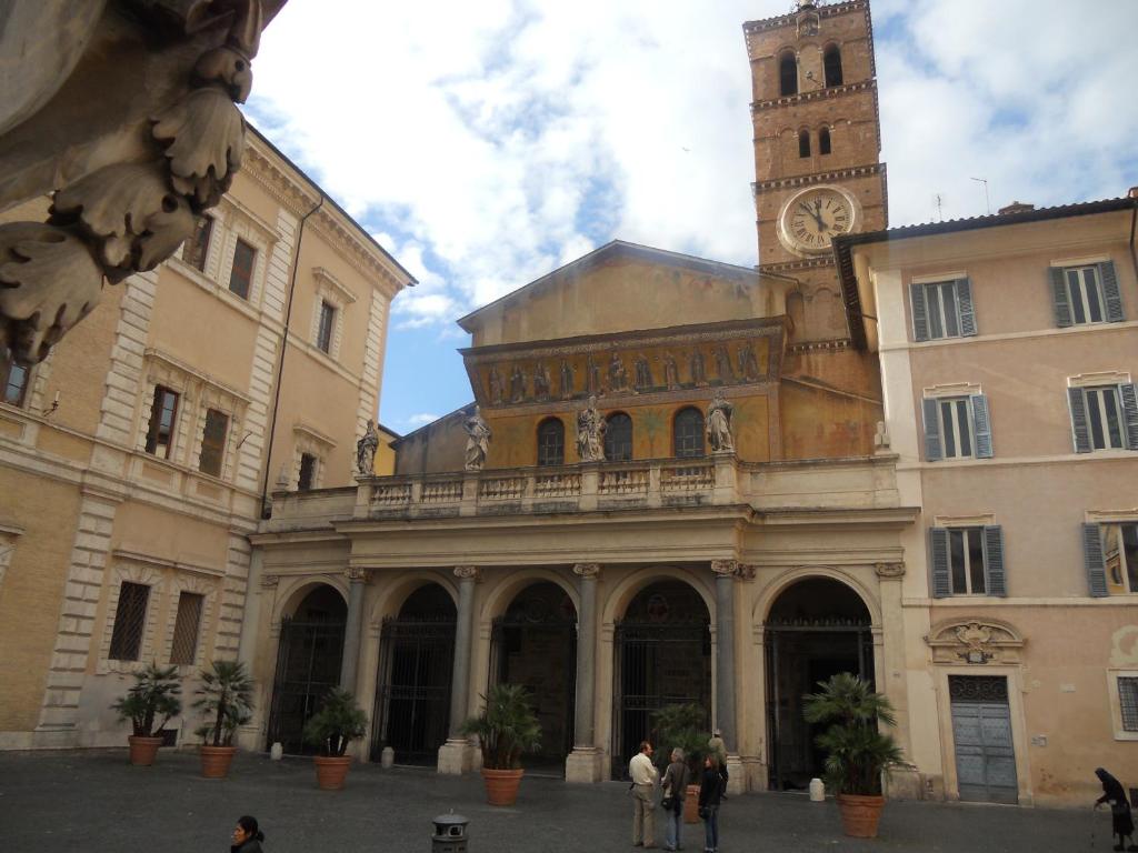 a large building with a clock tower in a city at Hotel Trastevere in Rome