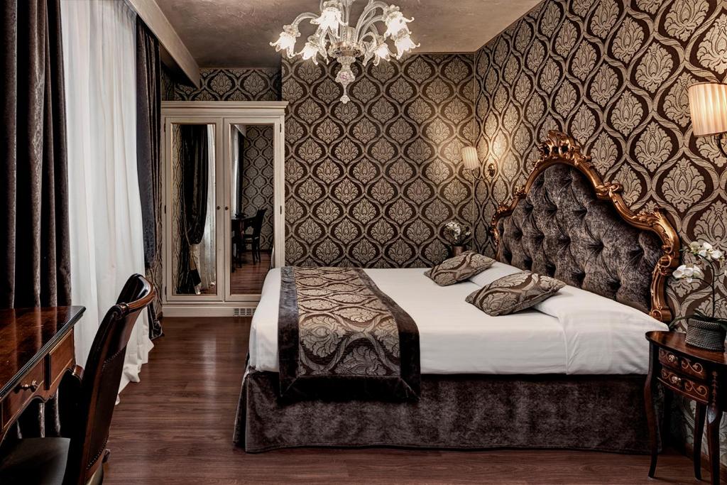 Postel nebo postele na pokoji v ubytování Hotel Tre Archi