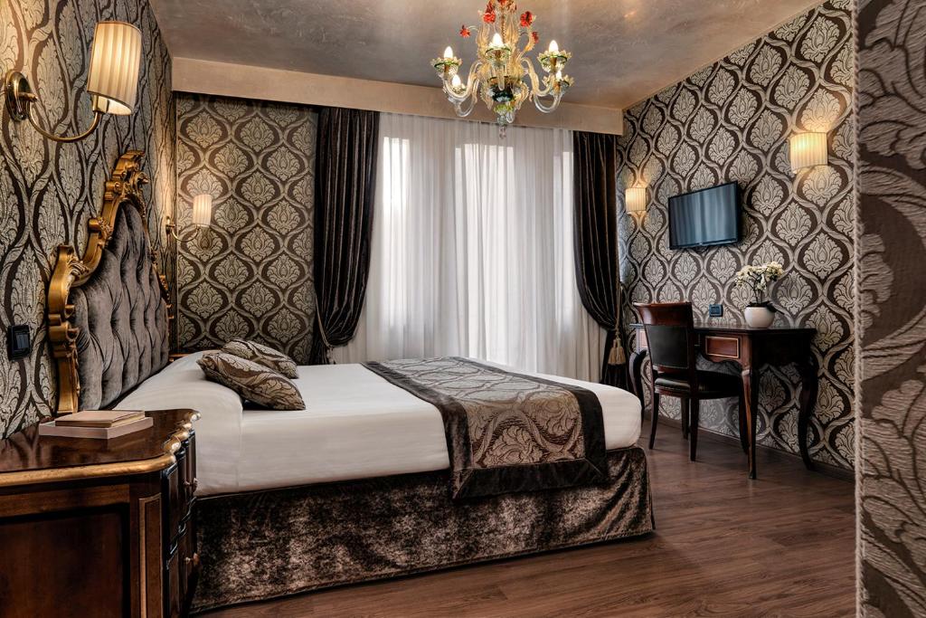 Postel nebo postele na pokoji v ubytování Hotel Tre Archi