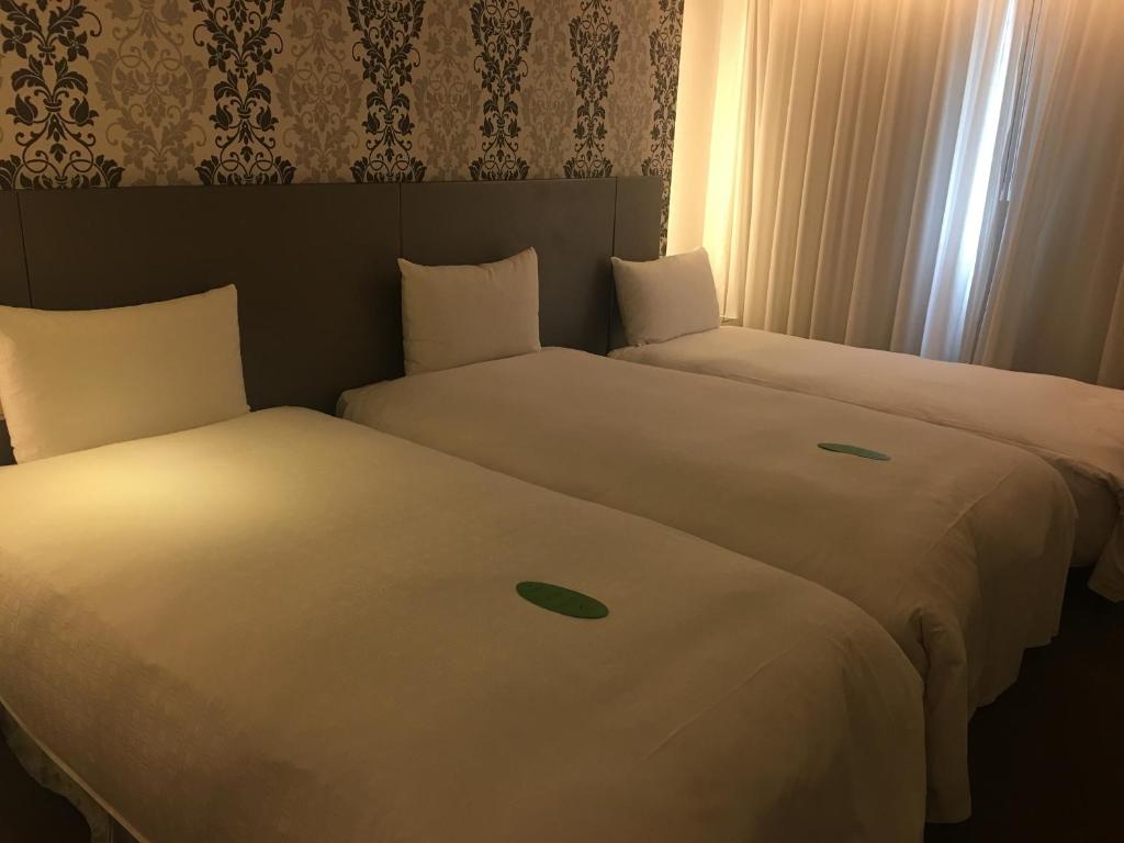 Voodi või voodid majutusasutuse Forward Hotel Taipei Nangang toas