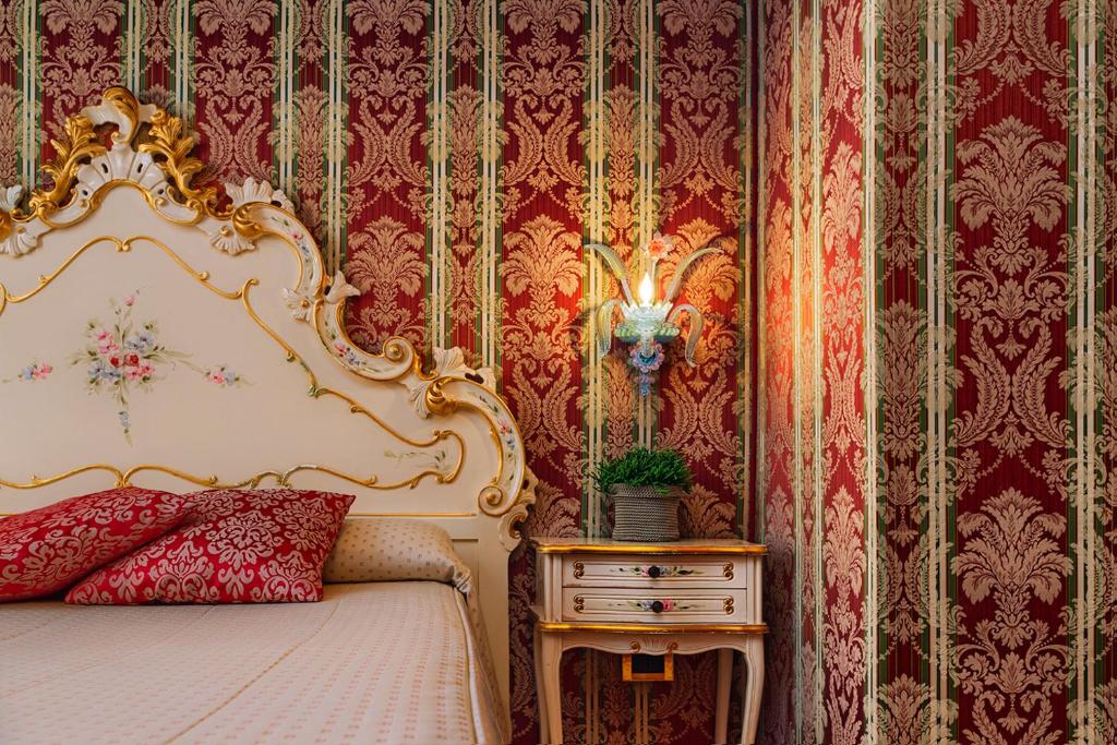 Postel nebo postele na pokoji v ubytování Hotel Tre Archi