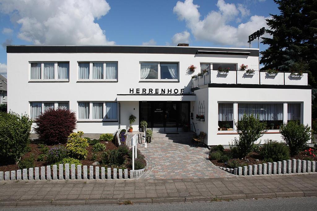 a white building with a sign on the front of it at Hotel Herrenhof in Lübeck