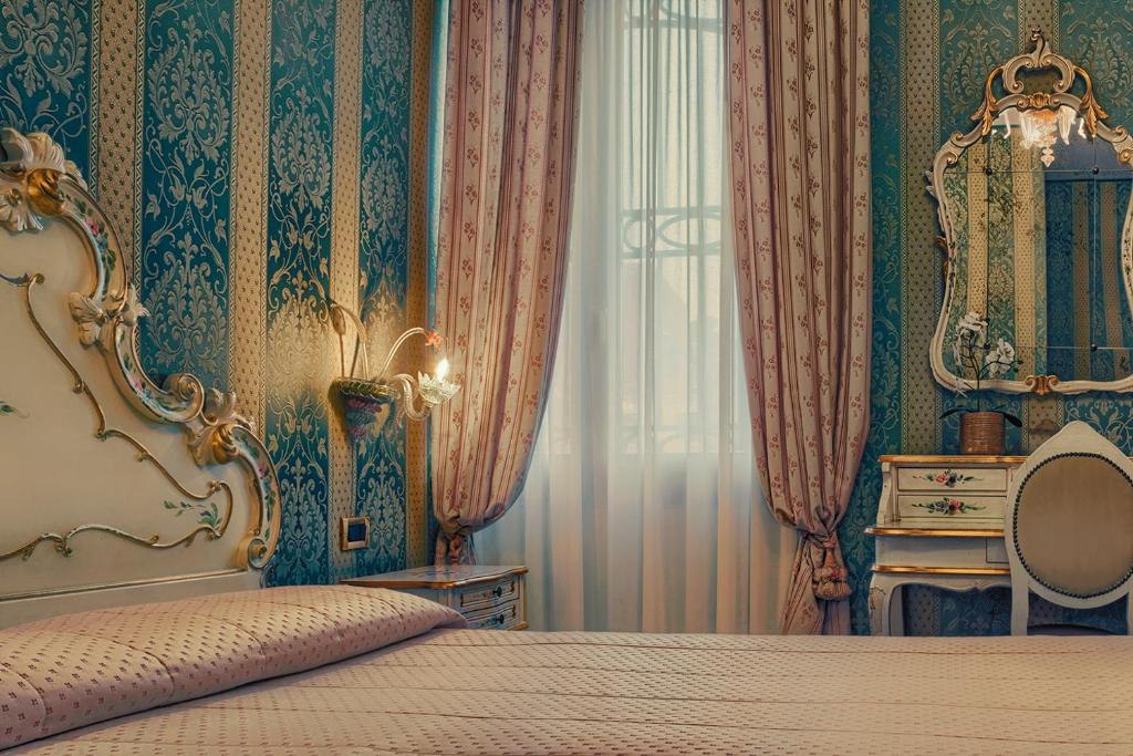 Postel nebo postele na pokoji v ubytování Hotel Tre Archi