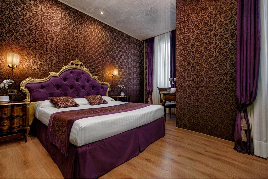 Postel nebo postele na pokoji v ubytování Hotel Tre Archi