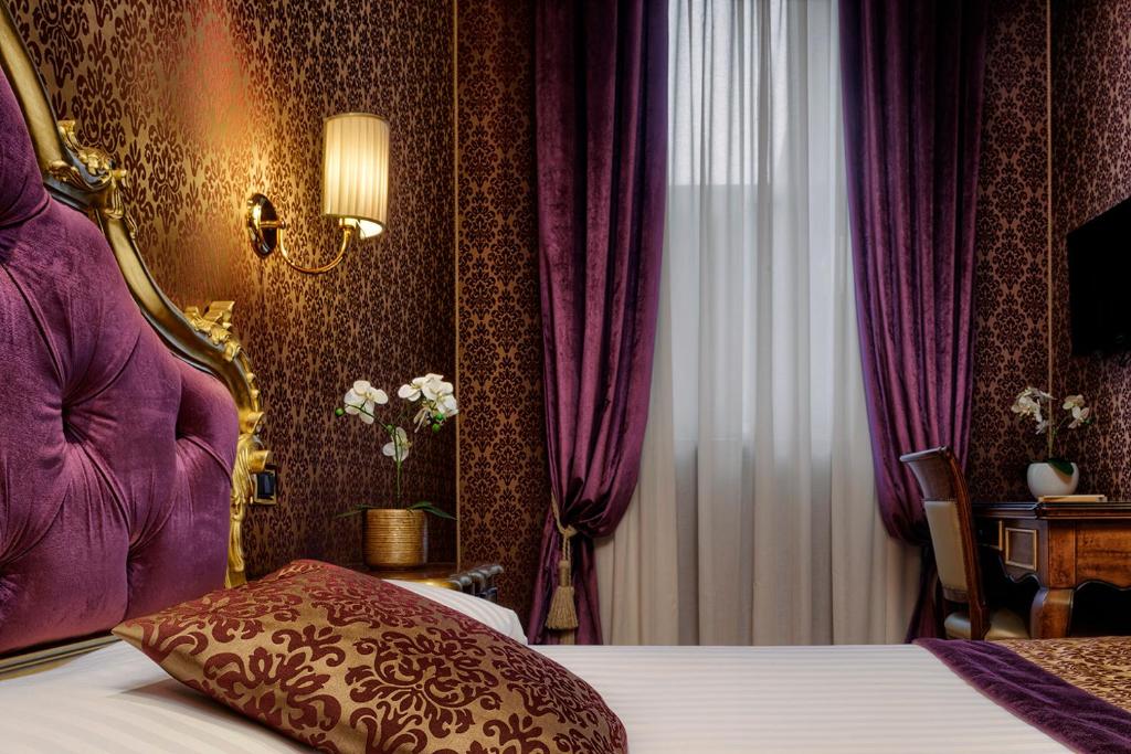Postel nebo postele na pokoji v ubytování Hotel Tre Archi
