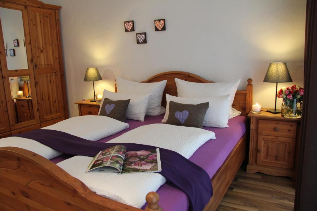 a bedroom with two beds with white and purple sheets at Gästehaus Schöberl in Füssen