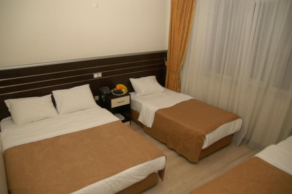 Postel nebo postele na pokoji v ubytování Merdan Hotel