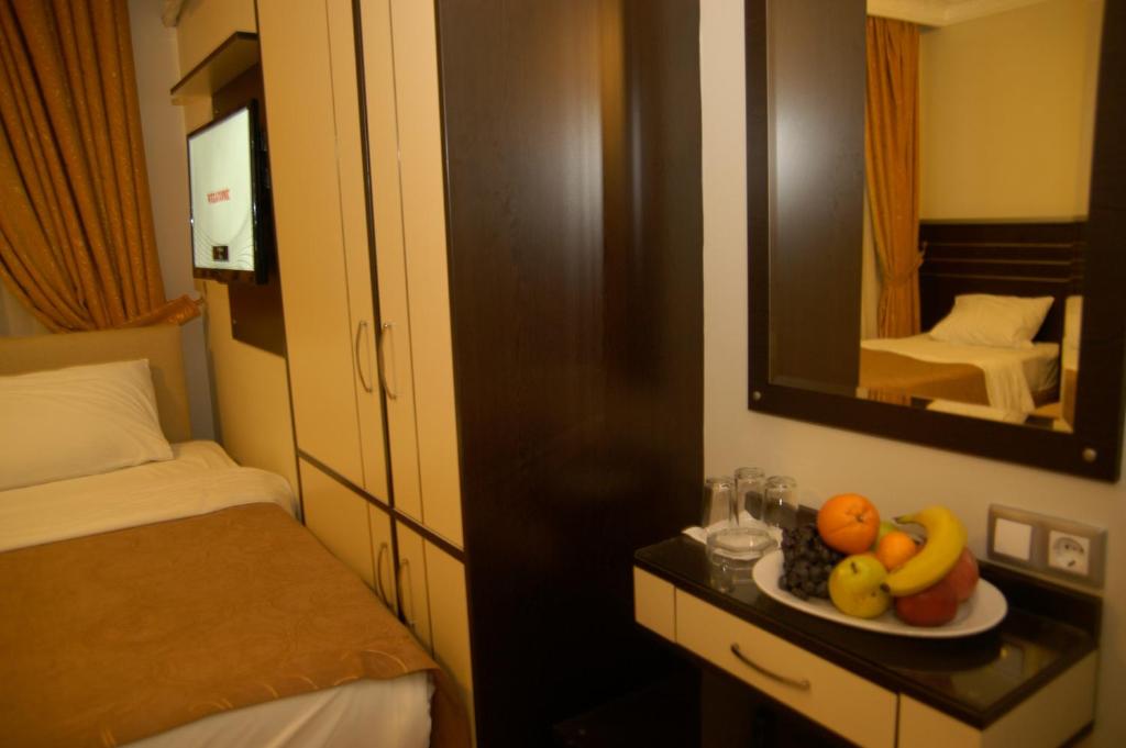 Postel nebo postele na pokoji v ubytování Merdan Hotel