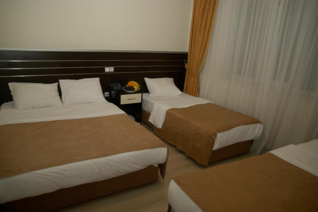 Postel nebo postele na pokoji v ubytování Merdan Hotel