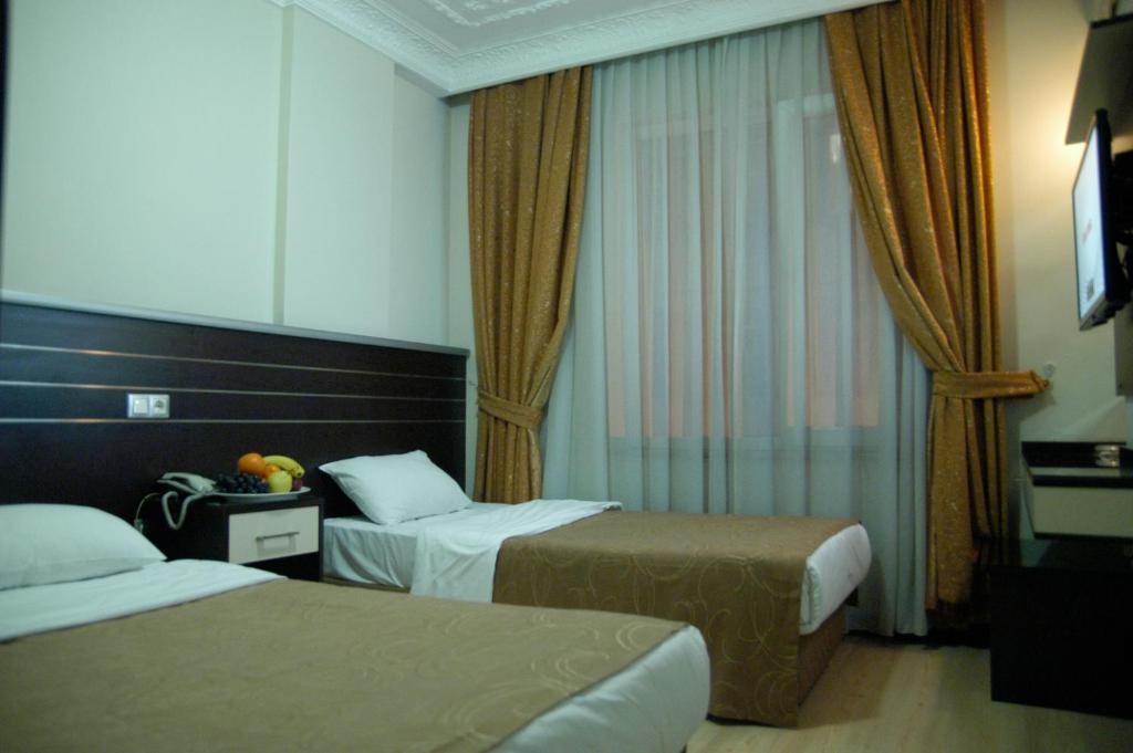 Postel nebo postele na pokoji v ubytování Merdan Hotel