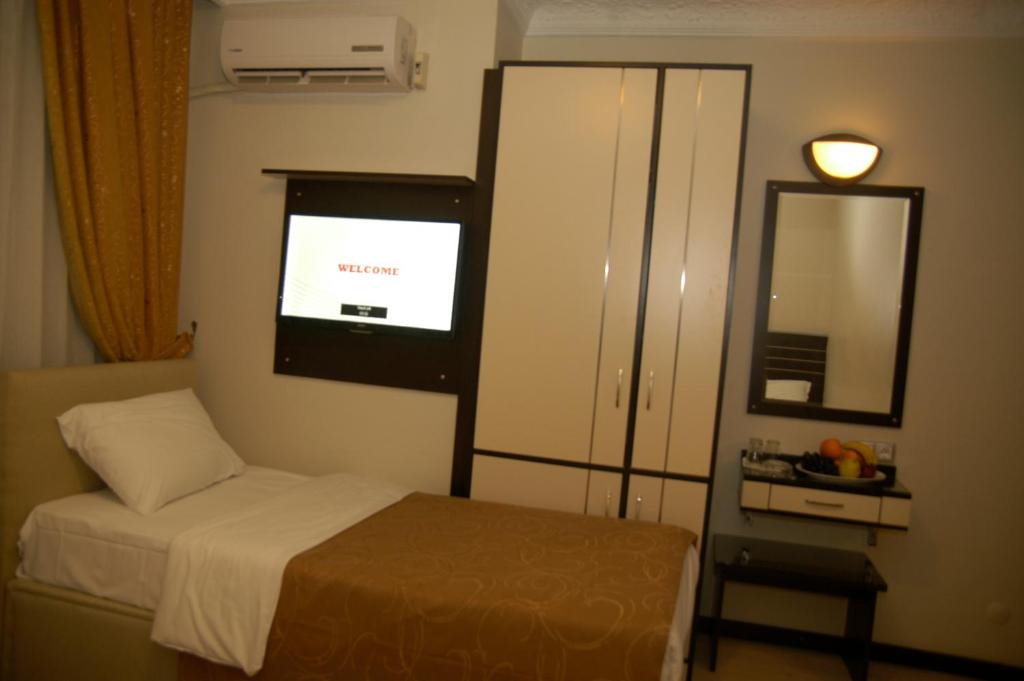 Postel nebo postele na pokoji v ubytování Merdan Hotel