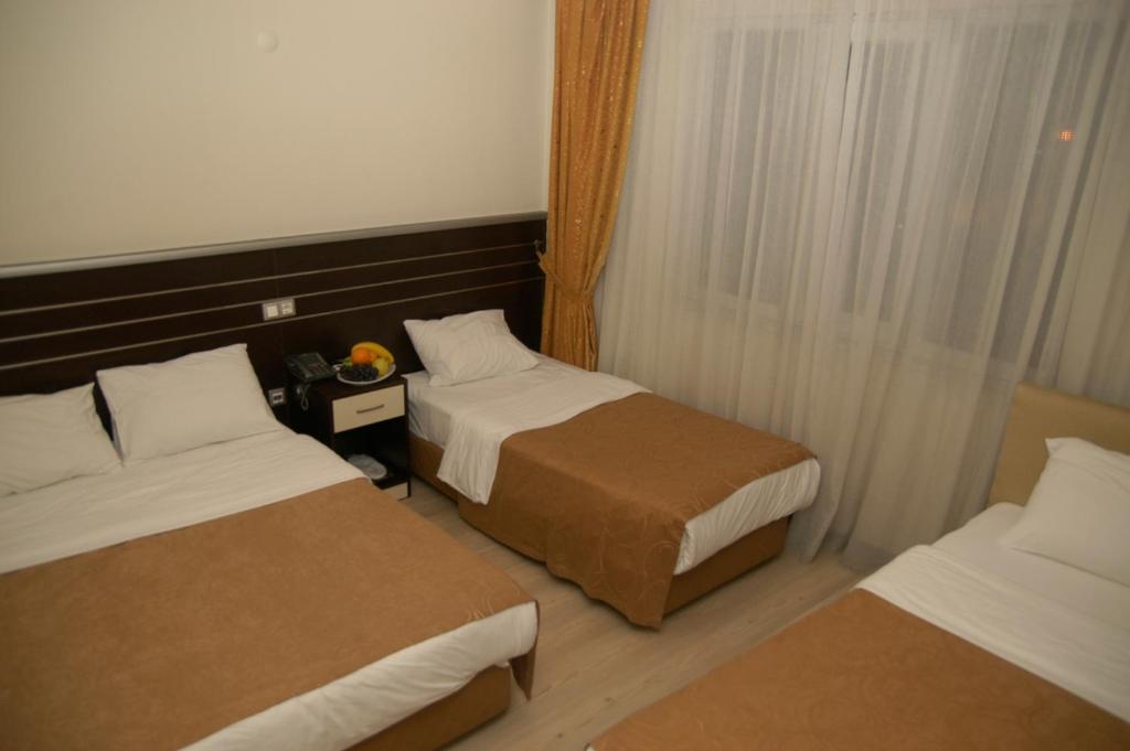 Postel nebo postele na pokoji v ubytování Merdan Hotel
