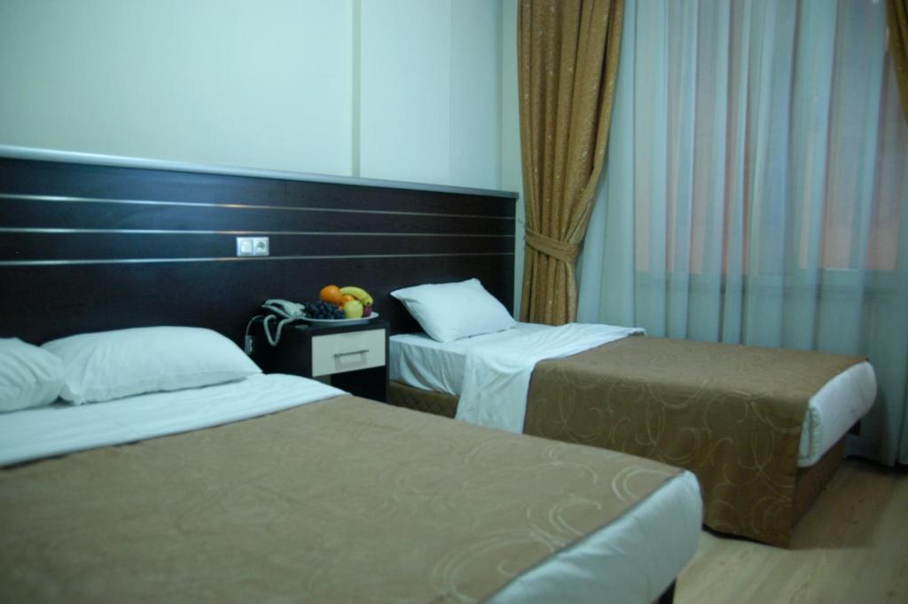 Postel nebo postele na pokoji v ubytování Merdan Hotel