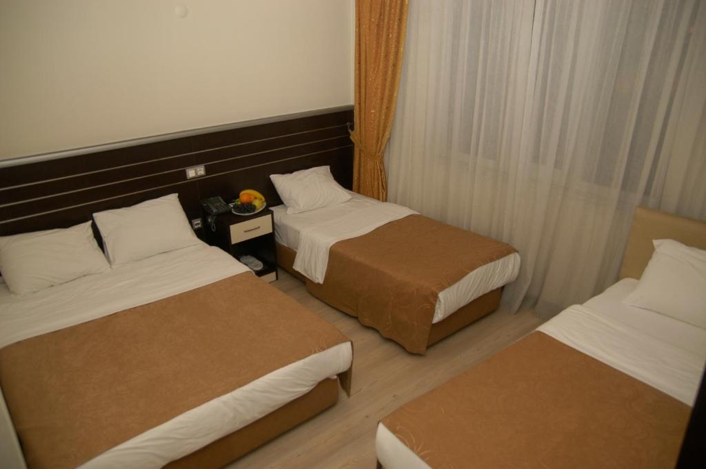 Postel nebo postele na pokoji v ubytování Merdan Hotel