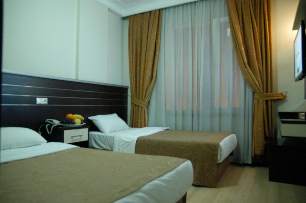 Postel nebo postele na pokoji v ubytování Merdan Hotel