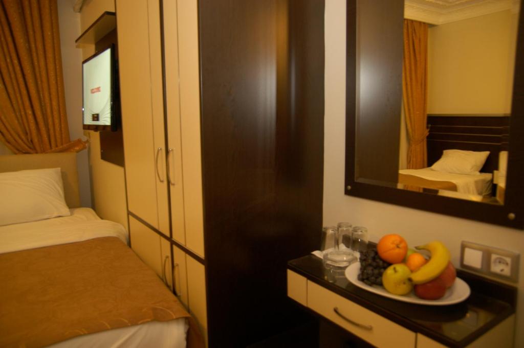 Postel nebo postele na pokoji v ubytování Merdan Hotel
