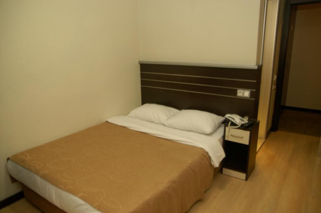 Postel nebo postele na pokoji v ubytování Merdan Hotel