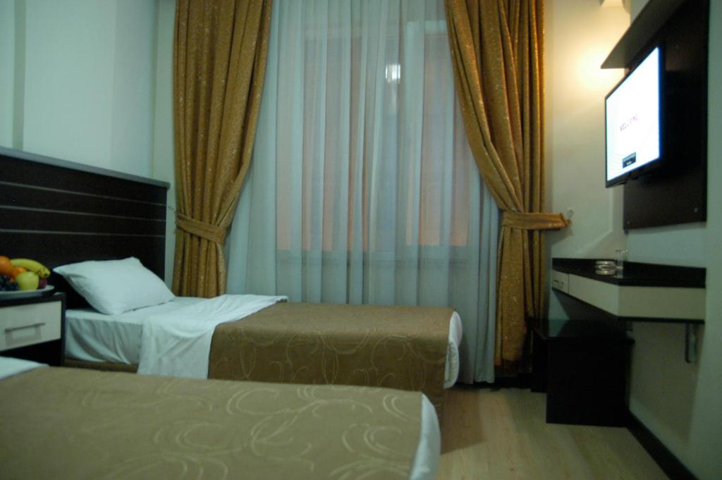 Postel nebo postele na pokoji v ubytování Merdan Hotel