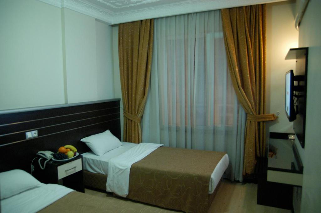 Postel nebo postele na pokoji v ubytování Merdan Hotel