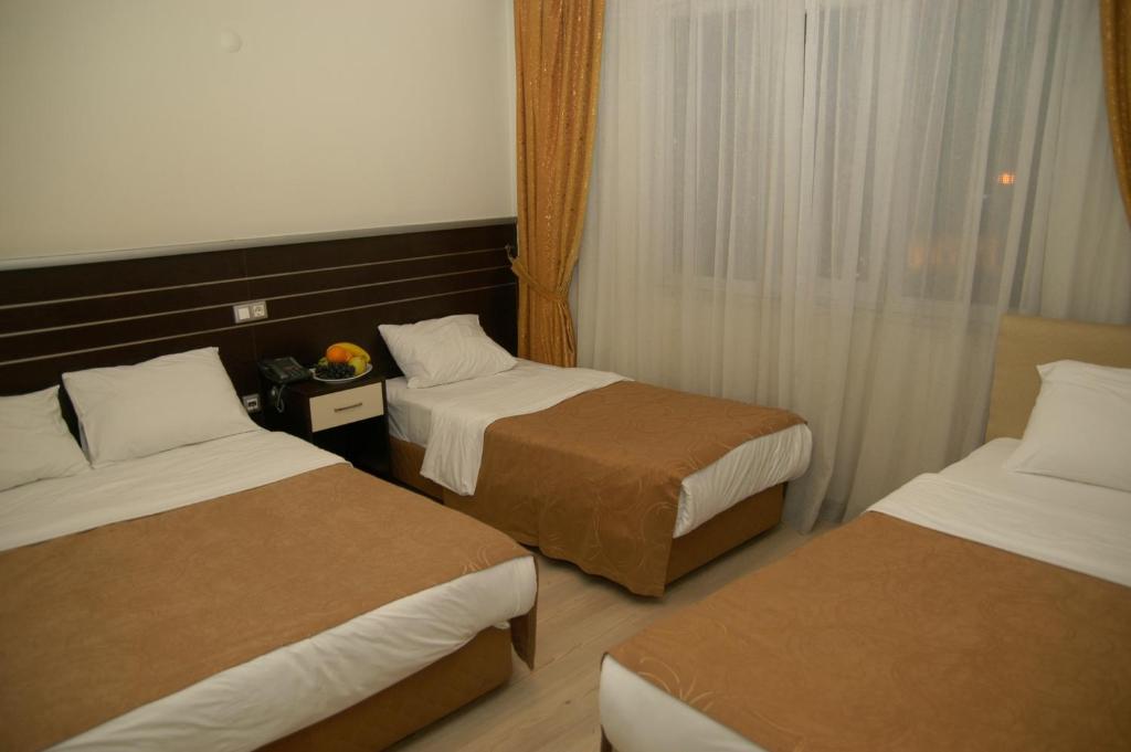 Postel nebo postele na pokoji v ubytování Merdan Hotel