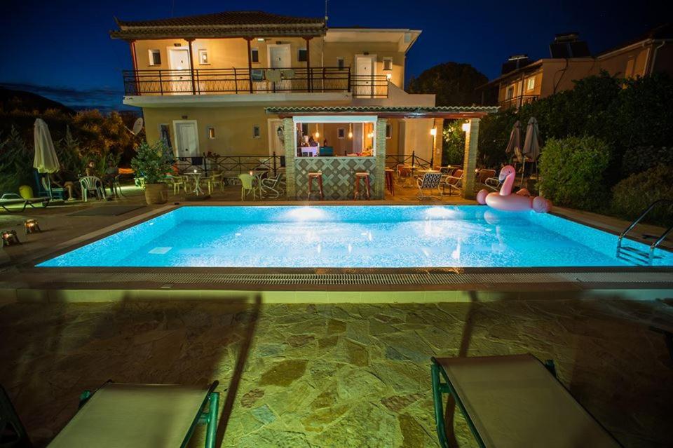 a large swimming pool in front of a house at Evan's Studios in Alykes