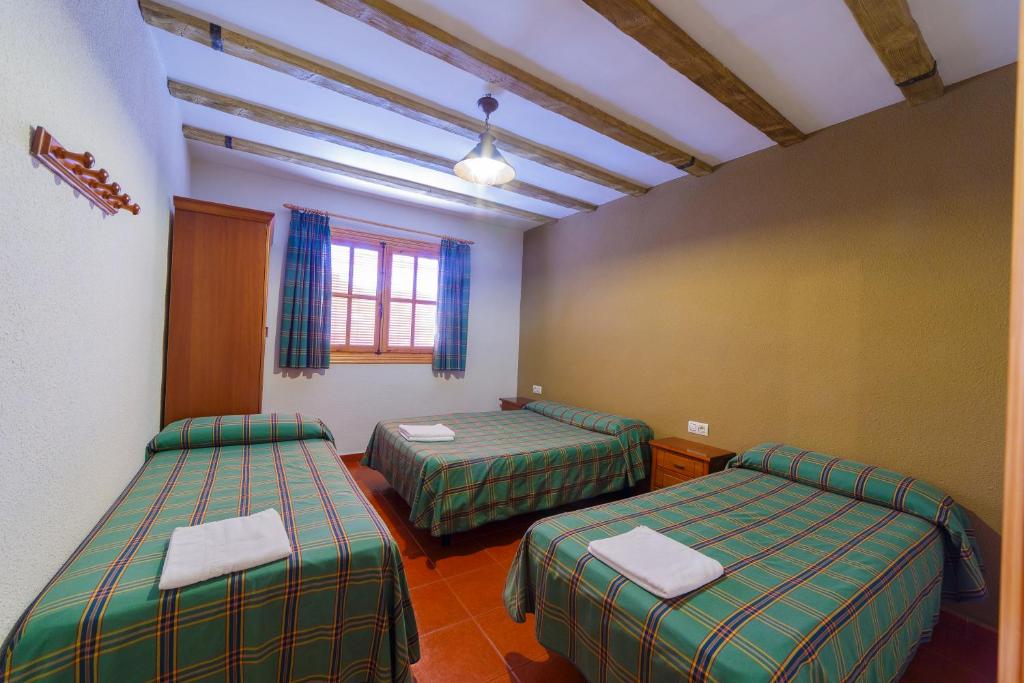 Postel nebo postele na pokoji v ubytování Apartamentos Ribera del Júcar