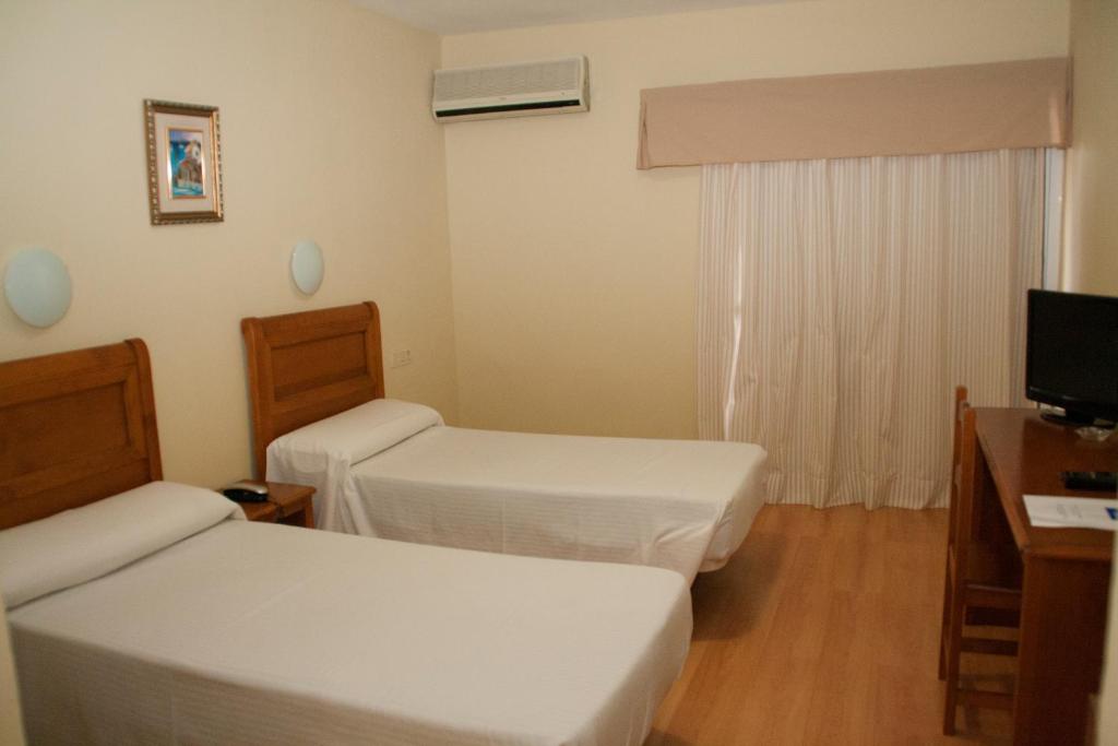 Postel nebo postele na pokoji v ubytování Hotel Anfora