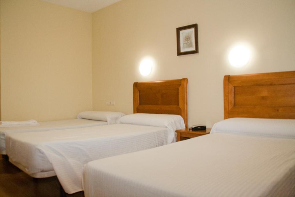 Postel nebo postele na pokoji v ubytování Hotel Anfora