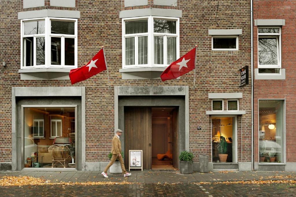a building with a flag on the front of it at Townhouse Design Hotel & Spa in Maastricht