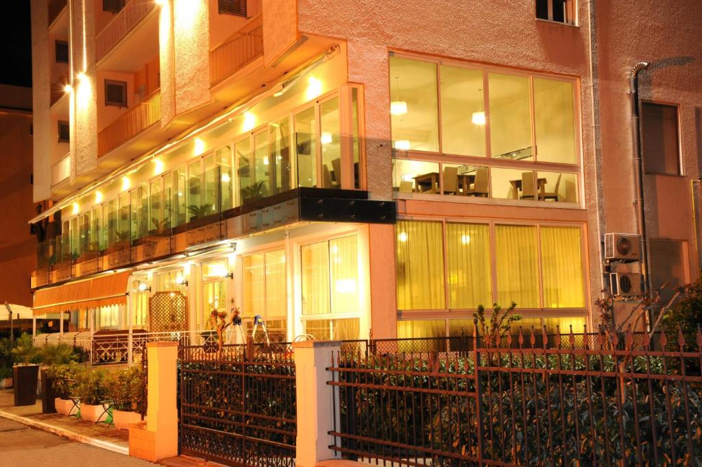 a building with a fence in front of it at Hotel dell'Amarissimo in Bellaria-Igea Marina