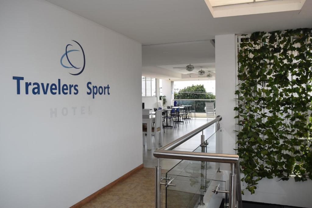 a lobby of a travelers store with a plant on the wall at Hotel Travelers Sport in Cali