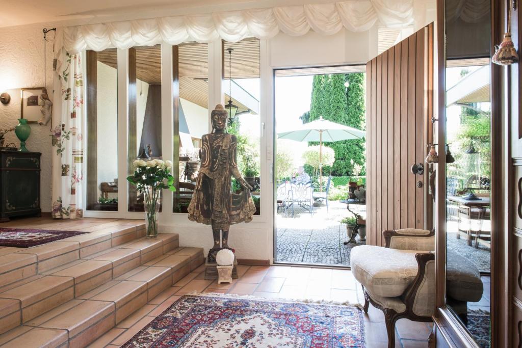 a statue of a woman standing in a living room at Charming and cosy apartment near Lucerne in Römerswil