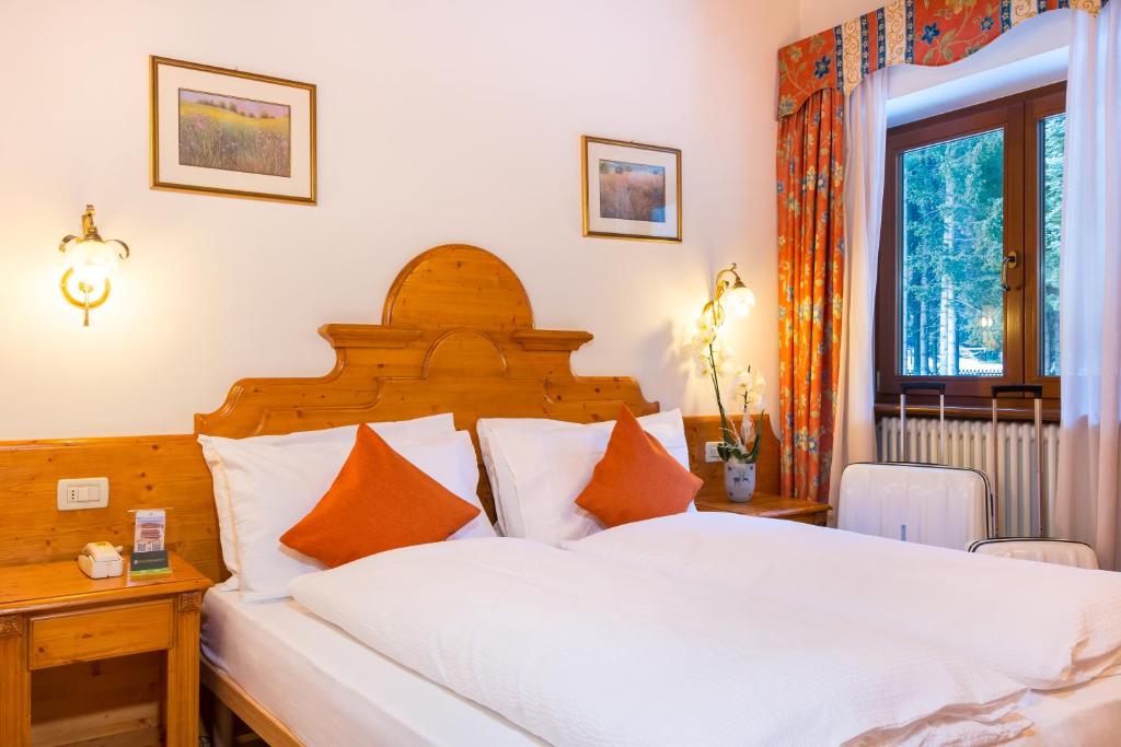 Postel nebo postele na pokoji v ubytování Hotel Bonapace ***S