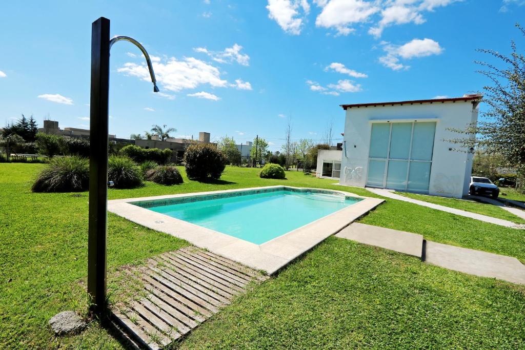 una piscina en un patio con luz de la calle en Hermosa Casa con Pileta Roldán Funes Rosario en Roldán