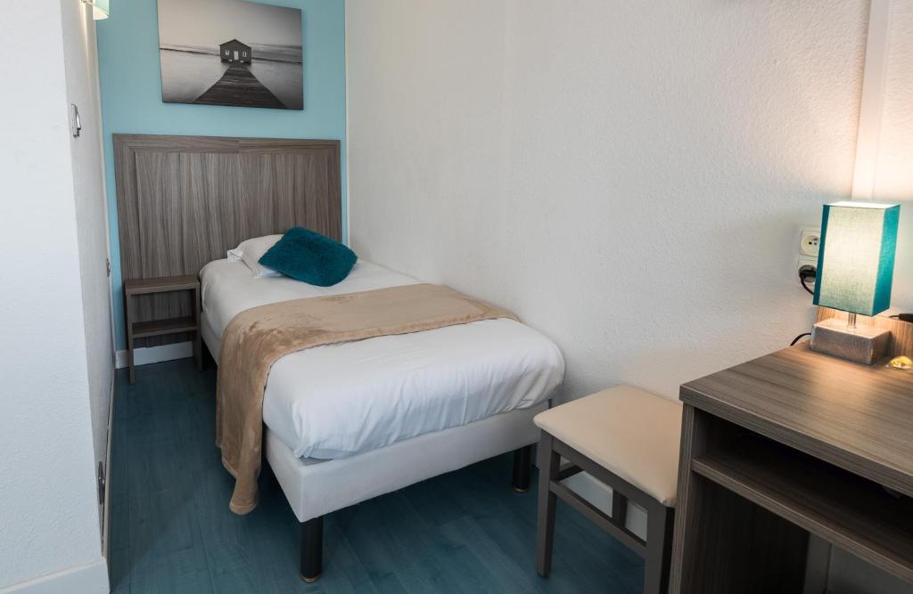 Postel nebo postele na pokoji v ubytování Hôtel Restaurant L'Evidence