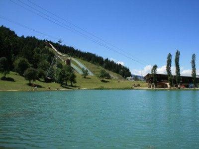 a large body of water with a hill in the background at Chalet Emilie in Courchevel