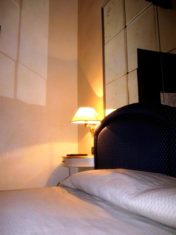a bedroom with a bed and a lamp on a table at Cà Doge in Venice